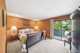 The primary suite offers designer tone paint finishes, a sliding door to a private view deck and plenty of wall space for your bedroom suite furnishings.