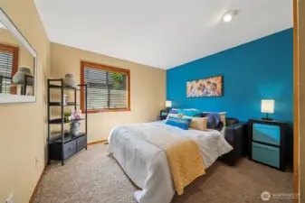 Bedroom 2 offers a guest space or media room as shown by this pull-out couch option. The room includes a large closet also.  Wood blinds are featured on all windows in the home.