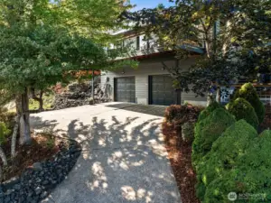 The front of the home rises up to the two car garage with an easy turn around for cars that are parked in the garage. Lovely landscaping lines the drive.