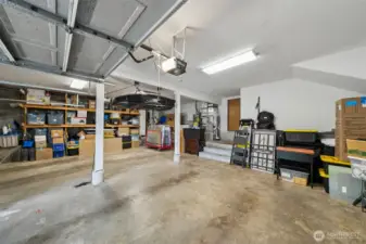 The huge two car garage offers space galore for storage with built-in shelves and a utility platform to keep the furnace and water heater away from vehicles.  More storage there too!