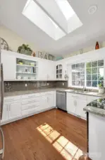 Beautifully updated kitchen with natural light + backyard views.