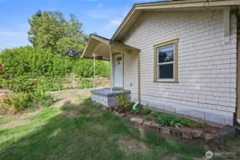 Driveway access to front door is close and easy, while the front garden bed shows care of ownership.