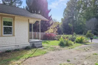 Lovely front yard gives a pretty visual, and also provides blueberries and raspberries, with annual blooms like crocosmia, lavender, daisies, and more!