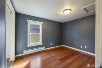 Newer laminate flooring in the bedroom and dramatic wall color in cool tones makes for a stylish feel in here.