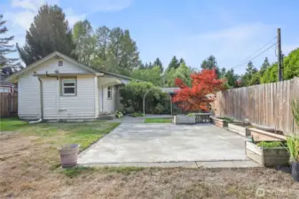 Expanded patio provides a wonderful space to enjoy this lovely yard, with garden boxes containing raspberries, pots with onions, and room to plant your own favorites!