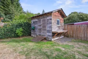 This shed is fabulous... the double doors speak to a time long ago, the potting bench on the side is darling and practical, and the newly fashioned ramp means easy in and out!