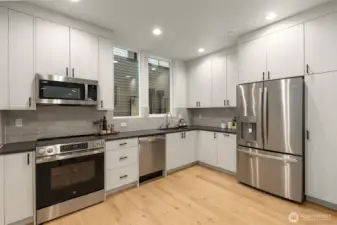 Luxury chefs kitchen 3cm quartz  (photos are of 1108B, similar floor plans & finishes)countertops & stainless steel GE appliances standard in all units