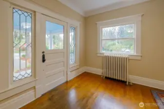 Step inside into this well-cared for historic home with new paint, and beautiful leaded glass windows, gleaming original hardwood floors, and spacious touches throughout.