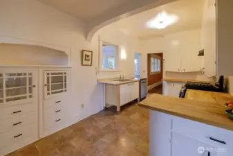Beautiful built-in cabinetry, butcher block countertops, and fresh paint in the kitchen.