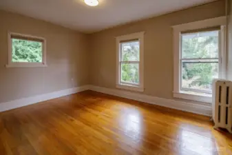 Second bedroom upstairs with wood floors, large closet, and lots of windows.