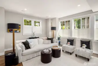 Step inside to a sun-drenched living room featuring rich hardwood floors and a warm, gas fireplace — the perfect space to relax or entertain.