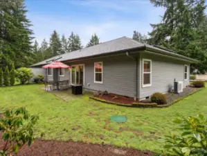 Another view of the home and spacious rear and side yard.