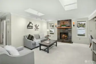 The living room features a slate fireplace.  Note the two skylights providing optimum natural light