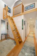 Entry area w/ built-ins and stairs to the spacious loft. At the end of the hallway is the door to the private elevator.