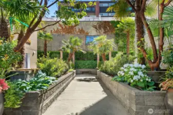 Step through the secure gate into a lush, landscaped courtyard—a hidden gem in the city.
