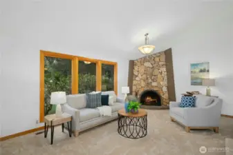 Living room with stylish fireplace. High end double pane Anderson windows & doors throughout home.