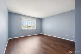 Primary bedroom with LVP flooring.