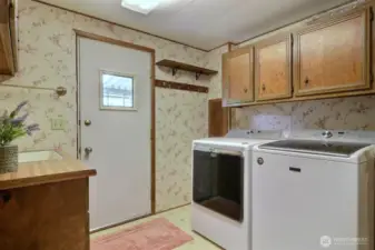 Side door enters into the laundry/mudroom with a newer washer and dryer included in the sale of home.
