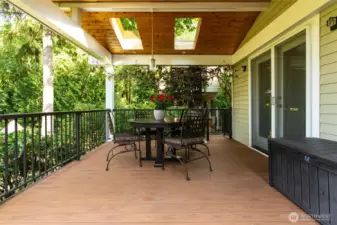 The expansive deck, accessible from the kitchen and dining room, offers an inviting space for lively outdoor gatherings