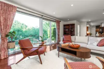 The glass wall in the great room seamlessly blends indoor and outdoor spaces and illuminates light throughout