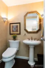 Main floor powder room with a heated TOTO Washlet toilet, pedestal sink, and Venetian-style painted walls