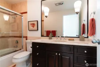 Marble tile throughout the floor, countertops, and tub/shower surround creates a luxurious feel in upstairs main bath