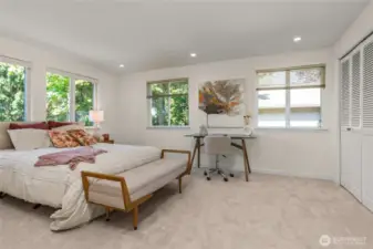 Spacious upstairs bedroom with private vanity and windows surround; can also serve as a bonus room