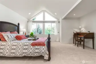 Alluring primary suite with architectural windows captivating light and offering peaceful nature views