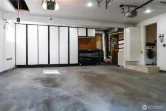 Oversized 2-car garage with built-in storage closets  and space for a work bench