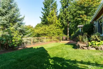 Fresh sod, lined with planting strips and raised flower beds offer the perfect space for year-round outdoor enjoyment