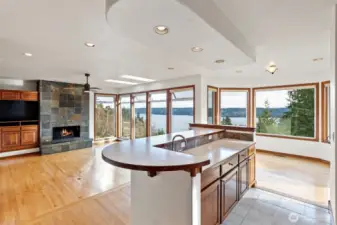 A look from the kitchen showing the gas fireplace and views.