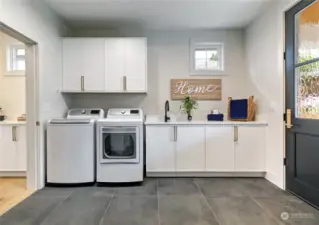 Main floor laundry/mudroom. A second laundry is featured on the 2nd floor, as well as full-size stacking washer/dryer in the ADU.