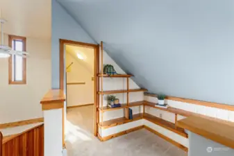 Top of the stairs to the left is a large walk-in closet and more built-in shelving.