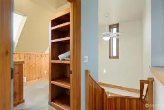 Top of the stairs to the right is the entry to the bathroom. More storage and beautiful wookwork.