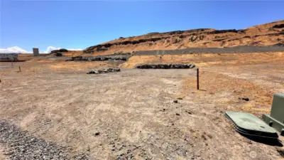 Level lot with retaining wall and utilities at the lot line!