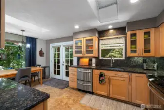 Maple cabinetry. French door opens to your covered deck with a screen.