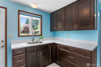 Another sink area with cabinets in the laundry room