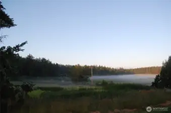 Morning fog graces the landscape view from the house.