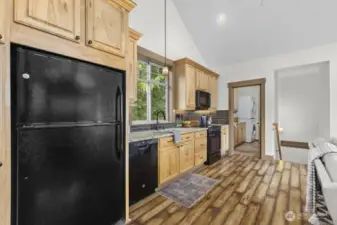 Kitchen features granite counters, tile backsplash, and under-cabinet lighting.