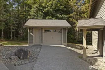 Convenient garage for all your yard essentials, with easy access for a riding lawnmower.