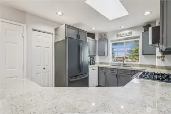 The kitchen features a gas range and a skylight. New sink and a great fridge. Soft close cabinets and a pantry.