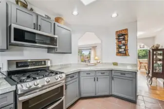 Granite countertops adorn the cupboards and a cute pass through to the living room area.