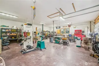 Finished shop has a wood burning fireplace, and TWO-220-amp service. Attic storage.The shop is complimented with an additional 2-car attached garage.