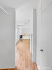 View from laundry and primary into the kitchen & living room.