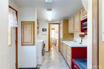 large utility room with storage and access from primary BR