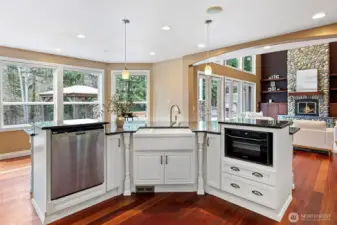Chef's kitchen with seating for eight, farmhouse sink and built in microwave.  Four sets of French doors open to the back patio... ideal for summer entertaining in a quintessential Pacific Northwest setting.