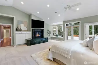Primary bedroom with gas fireplace, bay window and French doors that lead to the back patio.