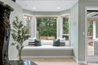 Primary bedroom with bay windows and French doors leading to the back patio.