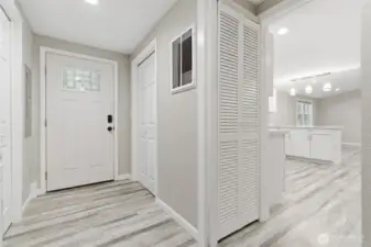 Entry way, laundry units are to the left, opens up to kitchen/ living room.
