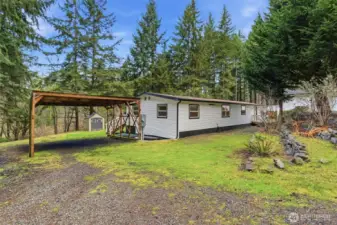 Covered Rv parking and power hook ups, this space offers aditional parking to the left (out of frame).